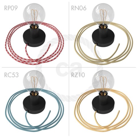 Spostaluce, the black metal light source with fabric cable and side holes